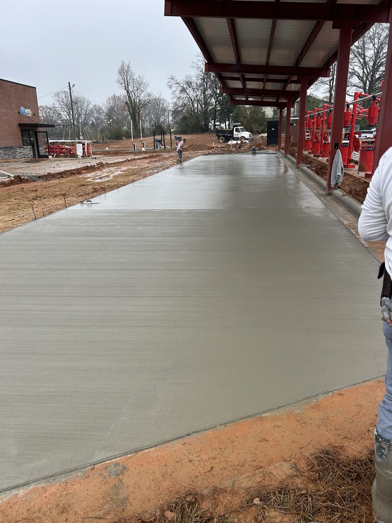 Broom finish being applied to commercial concrete pad for car wash in Spartanburg SC