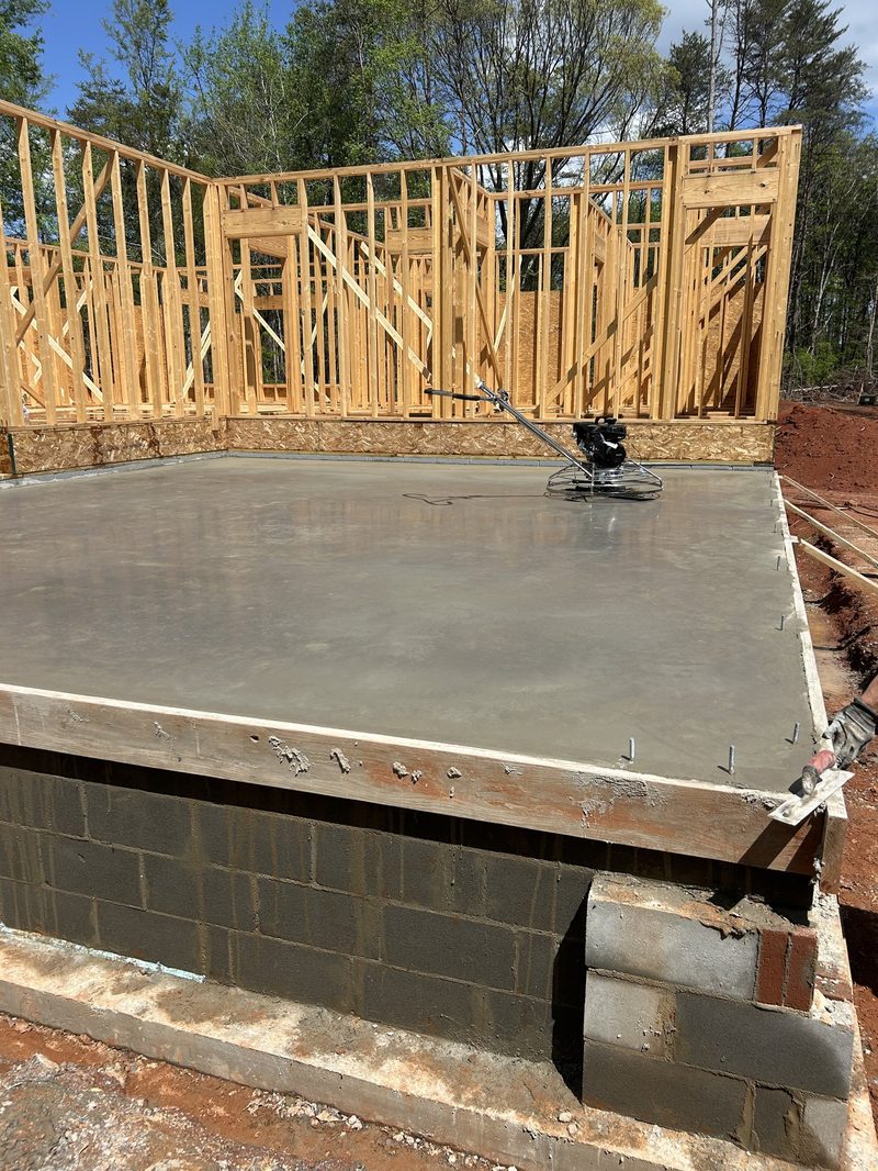 Power trowel finishing concrete foundation slab in Spartanburg SC