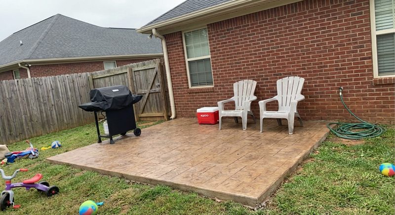 Family-size stamped concrete patio with outdoor furniture and grill in Spartanburg SC