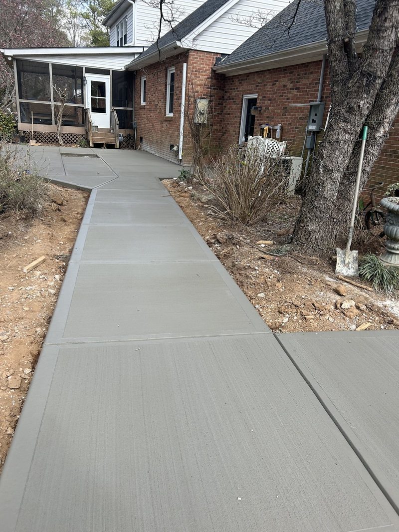 Broom finish concrete sidewalk alongside residential brick home in Spartanburg SC