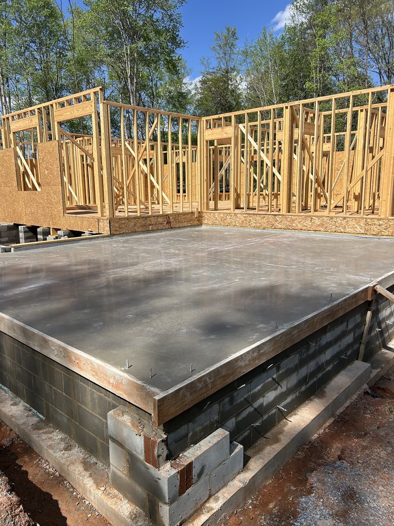 Concrete foundation slab with wall framing for new home in Spartanburg SC